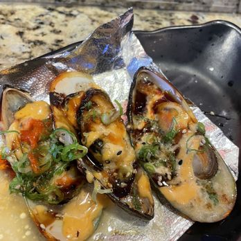 Fuji Roll & Sushi - Baked mussels. The one on the left has a little bit of Sriracha. - Japanese Near Me - Rialto, California Fuji Roll & Sushi - Baked mussels. The one on the left has a little bit of Sriracha. - Japanese Near Me - Rialto, California