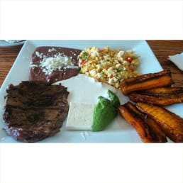 One of the typical plates they serve here. Grilled steak, scrambled eggs with veggies, beans cheese, fried plantains, Avocado. One of the typical plates they serve here. Grilled steak, scrambled eggs with veggies, beans cheese, fried plantains, Avocado.