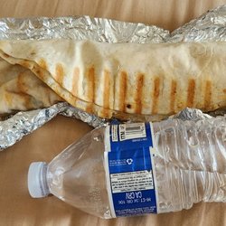 Califresh Halal Market - Chicken shawarma wrap (used a water bottle for reference). Comes with a soda can or water bottle. Gyro wrap looks like this as well.