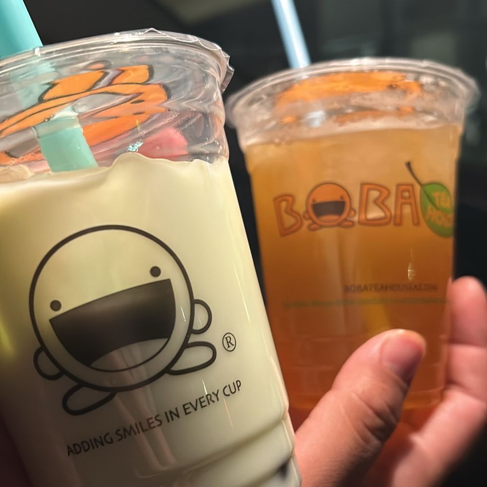 Boba Tea House - a hand holding two cups of boba tea - Coffee & Tea Near Me - Chandler, Arizona Boba Tea House - a hand holding two cups of boba tea - Coffee & Tea Near Me - Chandler, Arizona