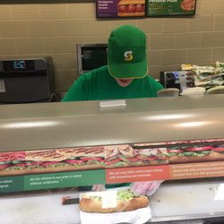 Subway - Sandwich artist making my oven roasted chicken sandwich.