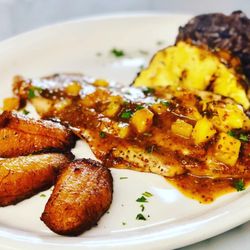 Bella Cuba - Tropical Chicken served on Grilled Pineapple with our Black Bean Rice and Sweet Fried Plantains