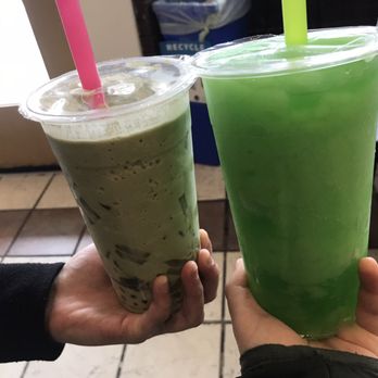 Lollicup - a person holding a green drink and a drink in a plastic cup - Coffee & Tea Near Me - Boulder, Colorado
