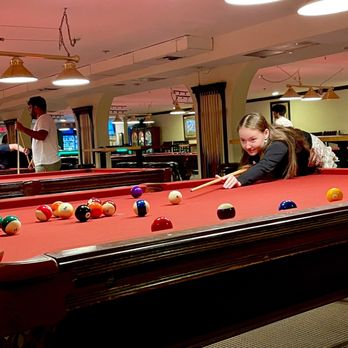 Lucky Shot Billiards - a woman playing pool - Pool Halls Near Me - Sunnyvale, California