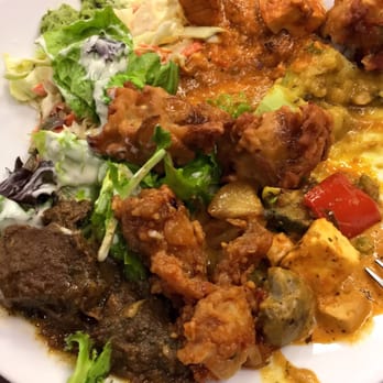 Himalayan Cafe - Everything on this plate paired so well together! I loved the goat curry, spiced fish, lentils and cabbage slaw with golden raisins! - Indian Near Me - Renton, Washington