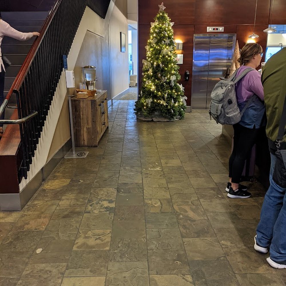 Alaska Airlines Lounge - Concourse D - Lobby - Checkin counter to the right, Christmas tree up front. - Airport Lounges Near Me - Seattle, Washington