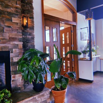 Coffea Roasterie - a fireplace and potted plants - Bakeries Near Me - Sioux Falls, South Dakota