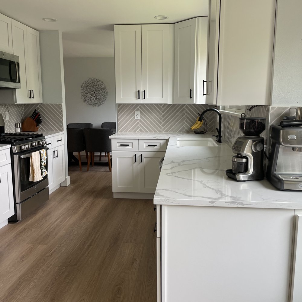 The Middle Man - a kitchen with white cabinets and stainless steel appliances - General Contractors Near Me The Middle Man - a kitchen with white cabinets and stainless steel appliances - General Contractors Near Me