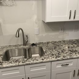 a kitchen counter and sink a kitchen counter and sink