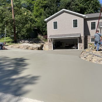 Your Waterproofer - workers pouring concrete into a driveway - Waterproofing Near Me - Independence, Ohio Your Waterproofer - workers pouring concrete into a driveway - Waterproofing Near Me - Independence, Ohio