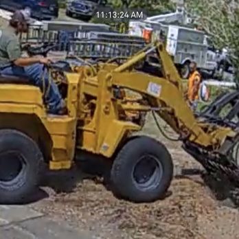 Quality Tree Experts - Tractor with fork bucket over area of damaged water pipe. - Tree Services Near Me Quality Tree Experts - Tractor with fork bucket over area of damaged water pipe. - Tree Services Near Me