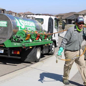 Senske Services - a man walking down the street with a hose - Tree Services Near Me - Kennewick, Washington Senske Services - a man walking down the street with a hose - Tree Services Near Me - Kennewick, Washington