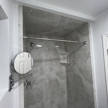 Homewerks - a bathroom with a shower and a mirror - General Contractors Near Me - Los Angeles, California