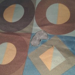 One example of the many burn holes in the bed spreads