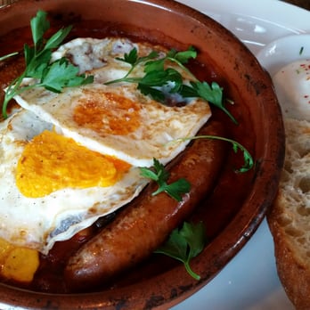 Medina Cafe - Tagine: 2 fried eggs, spicy sausage, seasonal vegetable stew, chickpeas, black olives & preserved lemon with grilled focaccia. - Breakfast & Brunch Near Me - Vancouver, British Columbia
