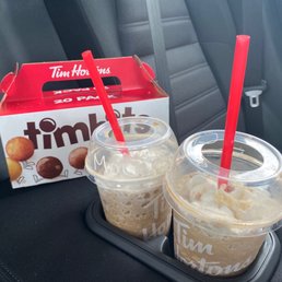 two cups of iced coffee and a box of tim hortons