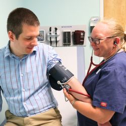 CHDC - CHDC medical provider measuring a patient's blood pressure.