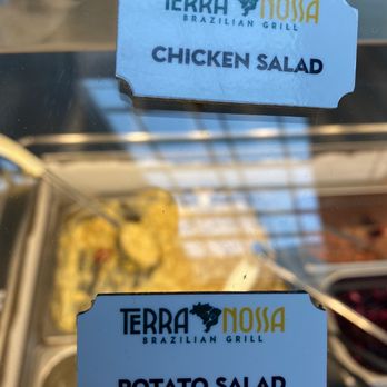 Terra Nossa Brazilian Grill - a close up of a sign that says terra nossa chicken salad and potato salad - Brazilian Near Me - Providence, Rhode Island