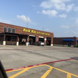 One car being serviced and 6 employees standing around. One car being serviced and 6 employees standing around.