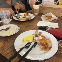 Buttermilk waffle with pecans and whipped cream and eggs. Buttermilk waffle with pecans and whipped cream and eggs.