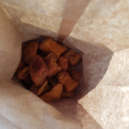 a brown paper bag filled with pieces of bread