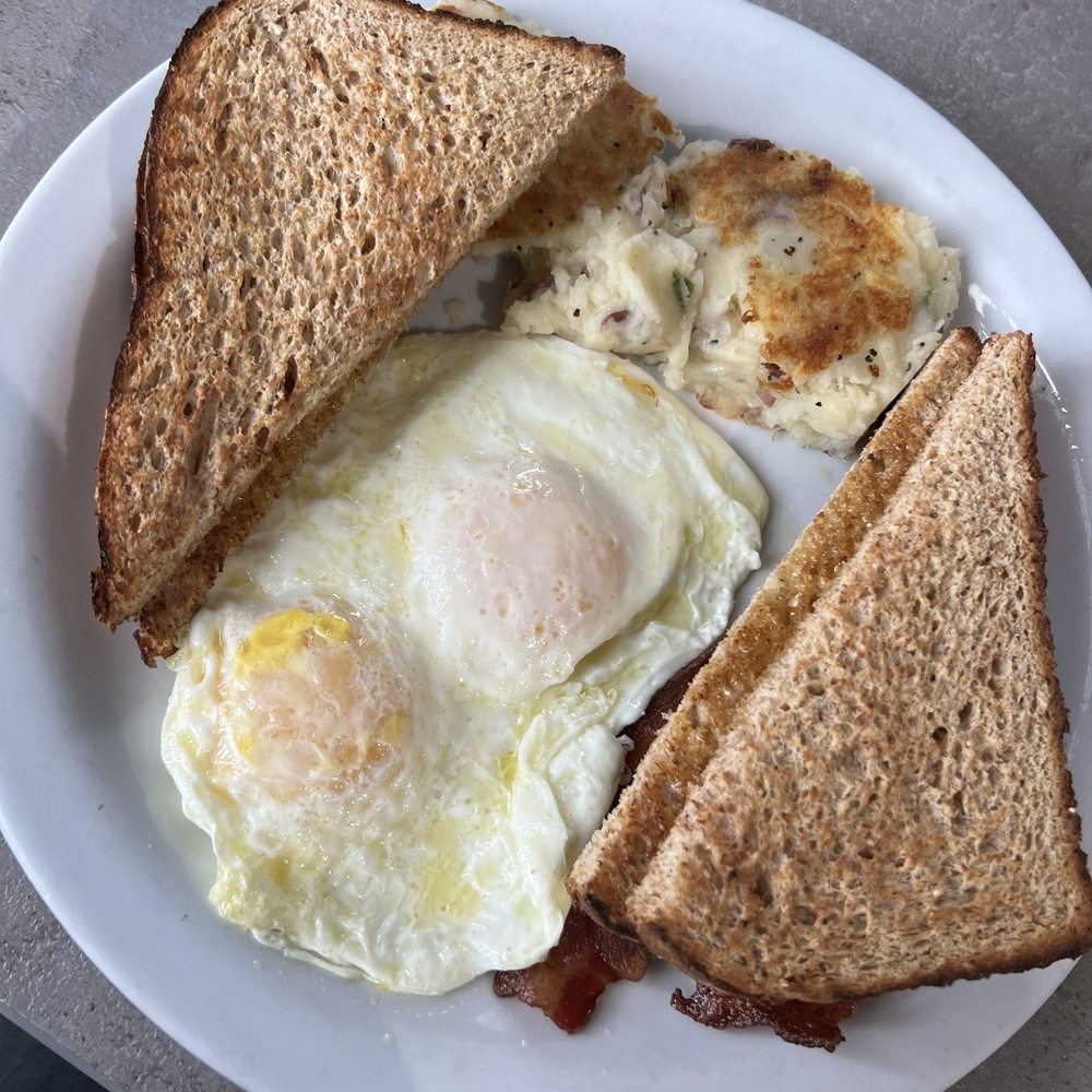 Eggs, toasts, potatoes and bacon Eggs, toasts, potatoes and bacon