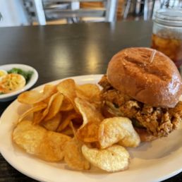 Fried Chicken Sandwich with a side of deviled eggs and black iced tea.