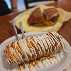 Super burrito with Al Pastor and Cubana in the background.