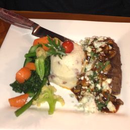 Steak with mushrooms and blue cheese; mashed potatoes, fresh vegetables.