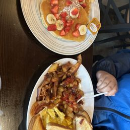 Strawberry and banana pancakes, toast, eggs, hash browns, bacon Strawberry and banana pancakes, toast, eggs, hash browns, bacon