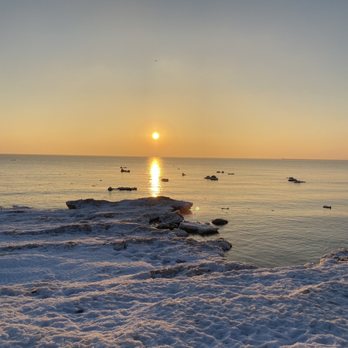 Foster Avenue Beach - 02/27/21 - Foster Avenue Beach just after sunrise, ice shelf on the left w/floating ice chunks in the lake - Beaches Near Me - Chicago, Illinois