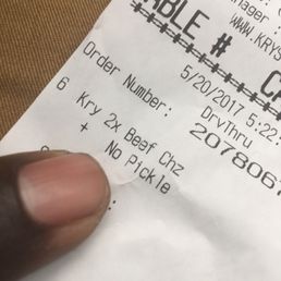 a hand holding a receipt