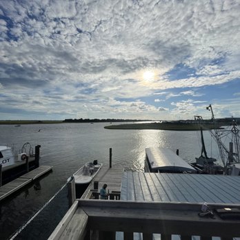 The Mullet Bar - a boat docked at a dock - Tiki Bars Near Me - Southport, North Carolina The Mullet Bar - a boat docked at a dock - Tiki Bars Near Me - Southport, North Carolina