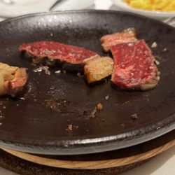 Mesón Txistu - Beef cooking on the cast iron at the table.