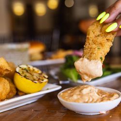Spoke & Wheel Tavern - American Grill & Bar - Crispy fish and chips with golden fries, tartar sauce, and fresh flavors at Spoke & Wheel Sedona