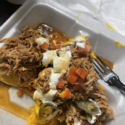 Half eaten pulled pork BBQ Nachos Supreme