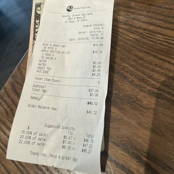 Another Broken Egg Cafe - A printed receipt from Another Broken Egg Cafe in El Paso, TX, showing food and beverage items, prices, and total amount, on a wooden table. - Southern Near Me - El Paso, Texas