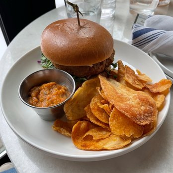 The Dandy Crown - Chicken Sandwich: Crisp Breaded Chicken, Pimiento Cheese, Cilantro Aioli, Greens, Sesame Bun Served with Tortilla Chips & Salsa Verde - Cocktail Bars Near Me - Chicago, Illinois The Dandy Crown - Chicken Sandwich: Crisp Breaded Chicken, Pimiento Cheese, Cilantro Aioli, Greens, Sesame Bun Served with Tortilla Chips & Salsa Verde - Cocktail Bars Near Me - Chicago, Illinois