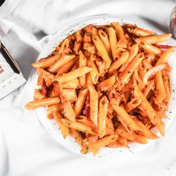 House Special Mama Mia: chicken, penne pasta, creamy marinara sauce, artichokes, onion, sun dried tomatoes,