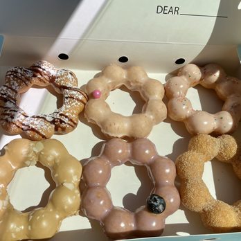 Mochinut - (Upper left) Chocolate drizzle, grapefruit, guava. (Lower left) Coffee, blueberry, churro. - Donuts Near Me - San Antonio, Texas
