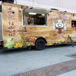 a food truck parked on a sidewalk a food truck parked on a sidewalk