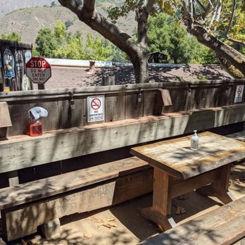 Big Sur Taphouse - Patio seating, with their rags on display. - Pubs Near Me - Big Sur, California Big Sur Taphouse - Patio seating, with their rags on display. - Pubs Near Me - Big Sur, California