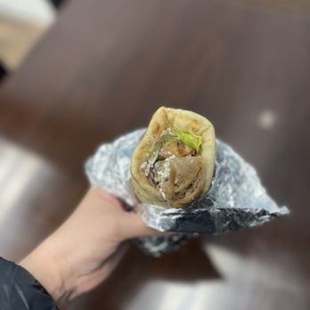 Knossos Restaurant - a hand holding a wrap of food - Greek Near Me - Herndon, Virginia Knossos Restaurant - a hand holding a wrap of food - Greek Near Me - Herndon, Virginia