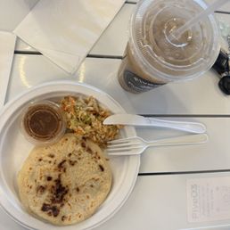 A pupusa,salsa in a container awkward an not original horchata.
