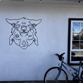 Heretic Coffee - Logo & bike on outside wall - Coffee & Tea Near Me - Portland, Oregon