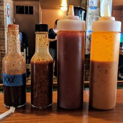MNM BBQ - Bbq sauces! Left to right, XXX Ghost Pepper sauce, Hot sauce, Sweet sauce, Carolina mustard