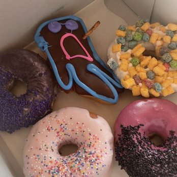 Voodoo Doughnut - Grape ape, voodoo donut, homer, hibiscus something, and that thing with captain crunch I can't recall the name of lol. - Donuts Near Me - Houston, Texas Voodoo Doughnut - Grape ape, voodoo donut, homer, hibiscus something, and that thing with captain crunch I can't recall the name of lol. - Donuts Near Me - Houston, Texas