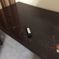 Boca Raton's Boca Inn - Dirty table and remote with batteries held in place with medical tape