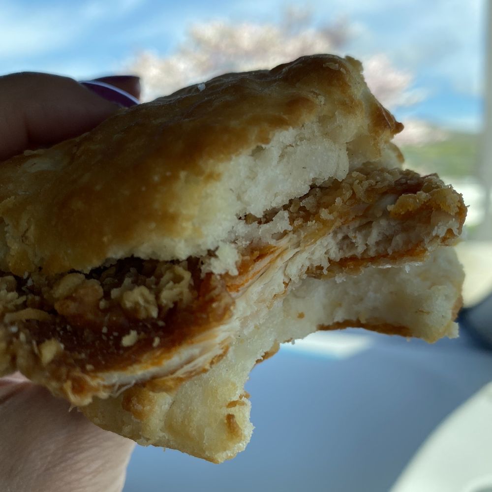 a hand holding a half eaten pastry