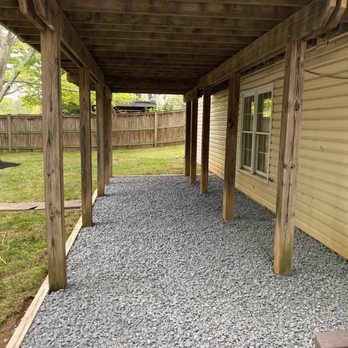 Omc Landscape - a covered patio with a bench - Landscaping Near Me